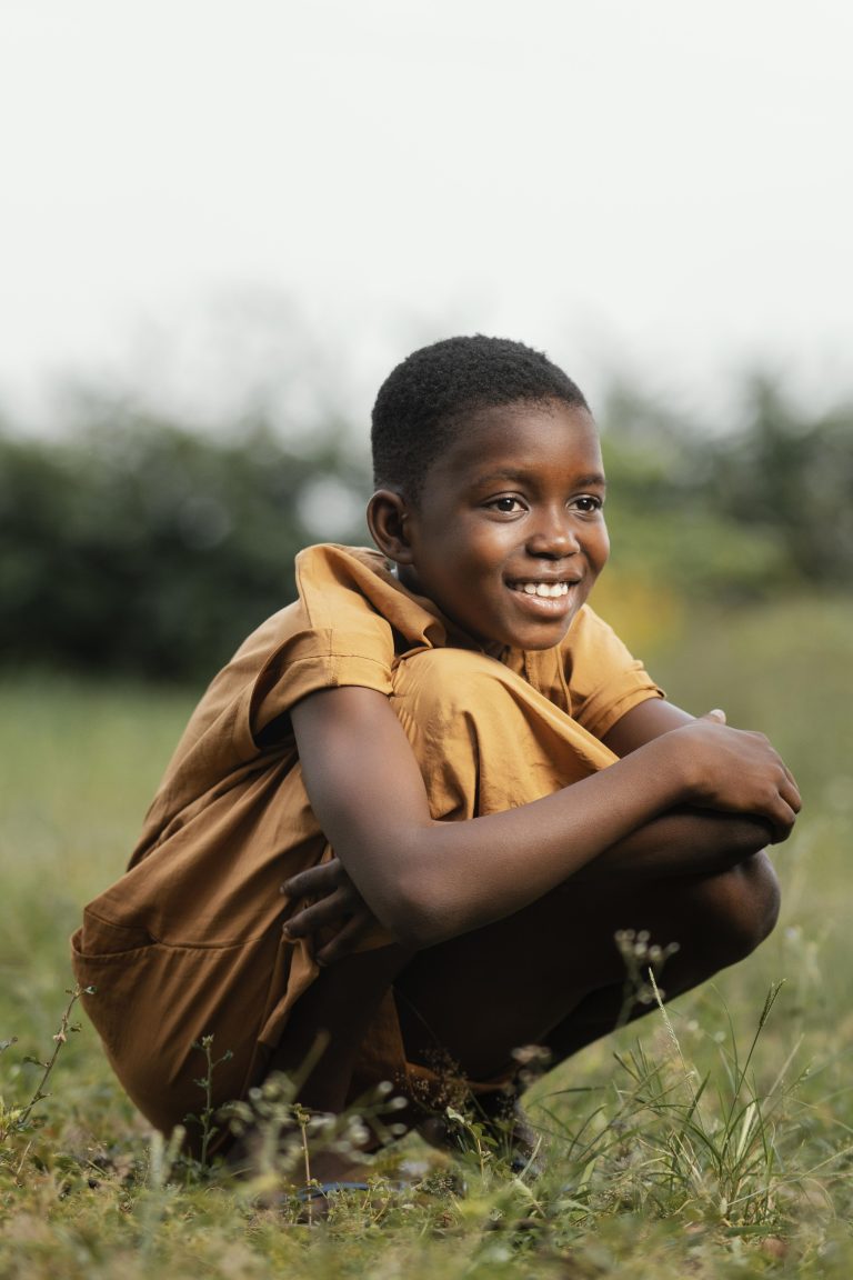 smiley-young-african-boy-standing-field